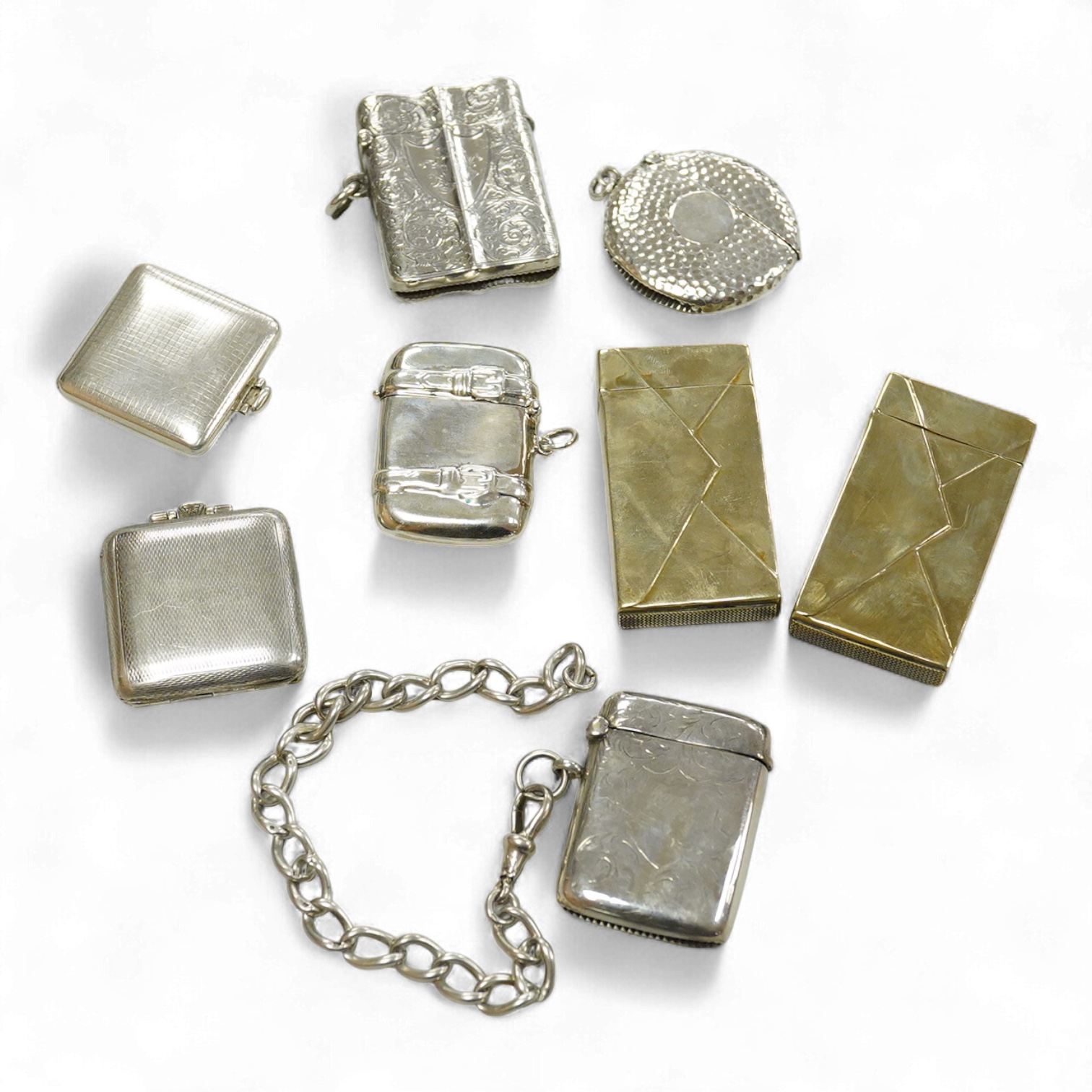 Three assorted silver vesta cases including one with a white metal chain, two gilded 900 standard white metal vesta cases, designed as a letter with postage stamp, 60mm, one 925 vesta case modelled as a satchel and two s